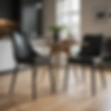 Stylish black upholstered kitchen chairs around a wooden dining table